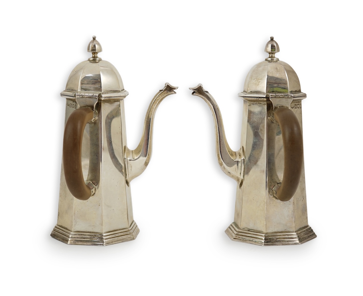 A pair of George V octagonal silver café au lait pots, by William Comyns & Sons Ltd